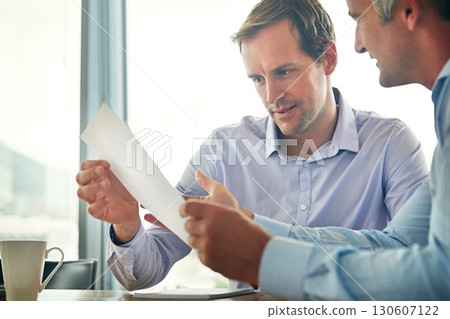 Business team, meeting and reading paper, information or report of corporate planning and strategy. Man with partner or manager in office for finance collaboration while happy about target or profile 130607122