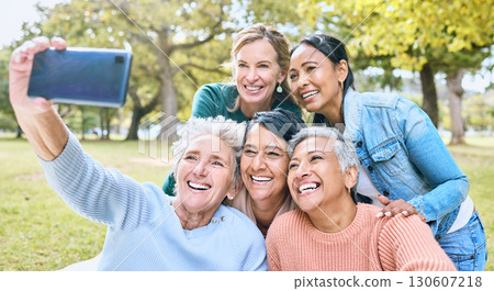 Senior woman, friends and phone for selfie at the park together with smile and peace sign in the outdoors. Happy group of silly elderly women smiling for photo looking at smartphone in nature Senior woman, friends and phone for selfie at the park together with smile and peace sign in the outdoors. Happy group of silly elderly women smiling for photo looking at smartphone in nature 130607218