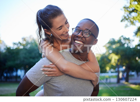 Love, interracial or couple of friends piggy back in a park on fun romantic date in nature bonding together. Relaxing, black man or happy woman laughing or enjoying quality time on a holiday vacation Love, interracial or couple of friends piggy back in a park on fun romantic date in nature bonding together. Relaxing, black man or happy woman laughing or enjoying quality time on a holiday vacation 130607224