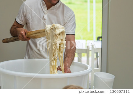 Artisan Cheese Making Stretching Curd with Traditional Tools in a Dairy Farm, Fresh Produce Artisan Cheese Making Stretching Curd with Traditional Tools in a Dairy Farm, Fresh Produce 130607311