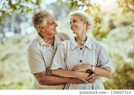 Love, hug or old couple in a park or nature bonding or holding hands in a happy marriage partnership. Retirement, senior man or romantic elderly woman hugging together in a relaxing holiday vacation Love, hug or old couple in a park or nature bonding or holding hands in a happy marriage partnership. Retirement, senior man or romantic elderly woman hugging together in a relaxing holiday vacation 130607324