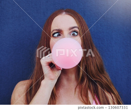 Comic, bubblegum and portrait of girl on blue background with silly, funny and crazy facial expression in city. Freedom, fashion and face of woman with candy bubble for trendy, cool and urban style Comic, bubblegum and portrait of girl on blue background with silly, funny and crazy facial expression in city. Freedom, fashion and face of woman with candy bubble for trendy, cool and urban style 130607331