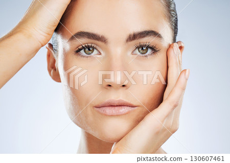 Beauty, skincare and portrait of a woman with makeup isolated on a grey studio background. Glow, clean and face of a spa dermatology model with facial health, hydration and wellness on a backdrop Beauty, skincare and portrait of a woman with makeup isolated on a grey studio background. Glow, clean and face of a spa dermatology model with facial health, hydration and wellness on a backdrop 130607461