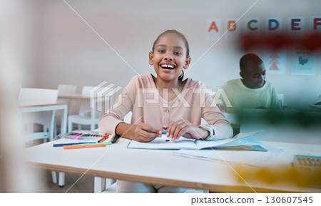Education, learning and portrait of child with smile in classroom for reading, writing and math in Montessori school. Books, students and happy girl at desk with fun notebook studying for future exam 130607545