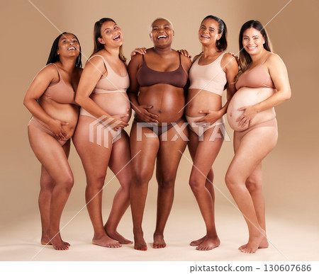 Pregnancy, body and portrait of happy friends in a studio for diversity, motherhood and prenatal wellness. Maternity, beauty and pregnant women showing baby bump stomach together by beige background. 130607686