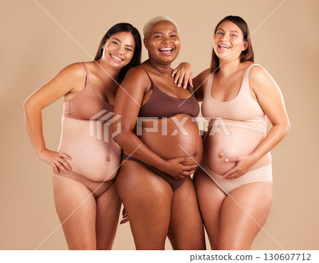Portrait, beauty and laugh with pregnant friends in studio on a beige background for diversity or motherhood. Family, love and pregnancy with a woman friend group showing their baby bump stomach 130607712