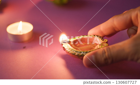 Closeup of hand holding lit candle Closeup of hand holding lit candle 130607727