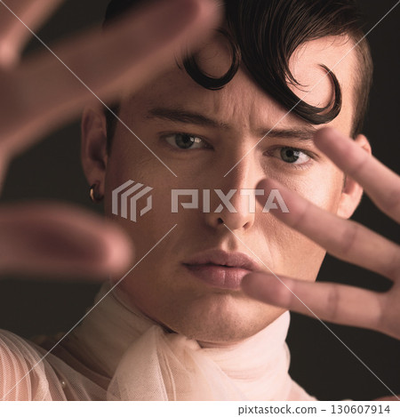 Beauty portrait of transgender man isolated on dark background for creative and queer fashion aesthetic. Young lgbtq model or gay person face with cosmetics, makeup and hands for art style in studio Beauty portrait of transgender man isolated on dark background for creative and queer fashion aesthetic. Young lgbtq model or gay person face with cosmetics, makeup and hands for art style in studio 130607914