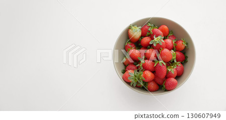 Top View of Fresh Strawberries in a Bowl on White Background 130607949