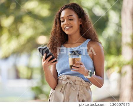 Coffee, phone and black woman typing at park, outdoors or outside. Cellphone, tea or happy female with caffeine while texting, social media or networking, scrolling or messaging on mobile smartphone. Coffee, phone and black woman typing at park, outdoors or outside. Cellphone, tea or happy female with caffeine while texting, social media or networking, scrolling or messaging on mobile smartphone. 130607975