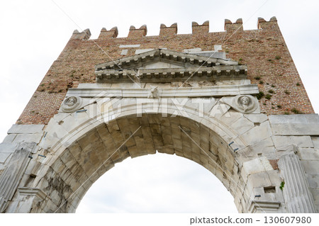 Triumphal Arch of Augustus. Rimini old Italian city center landmark. House square tower. Italy 130607980