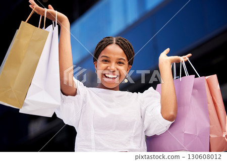 Portrait, shopping and an excited black woman customer carrying bags in a mall for retail or consumerism. Sale, product and fashion with a young female consumer or shopping buying from a store 130608012