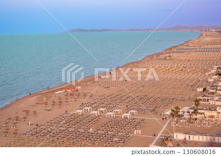 Wide sandy beach with sun loungers and umbrellas view from above. Evening on the Rimini coast 130608016