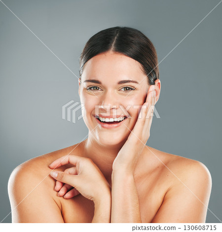 Beauty, skincare and woman portrait of a happy face with wellness, facial and skin glow. Isolated, studio background and cosmetic dermatology treatment of a young person with happiness from cosmetics Beauty, skincare and woman portrait of a happy face with wellness, facial and skin glow. Isolated, studio background and cosmetic dermatology treatment of a young person with happiness from cosmetics 130608715