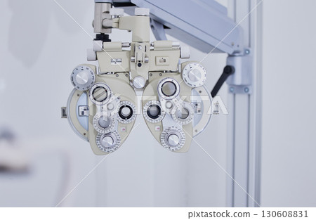 Phoropter, medical optometry and equipment in hospital for eye test or examination. Vision, healthcare and technology or tools for ophthalmology for eyecare, health and eyesight wellness in clinic. 130608831