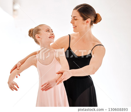 Ballet, learning class and dance teacher with child student in studio for dancing, art and coaching. Girl smile with woman ballerina coach or dancer to learn balance and academy performance with arms 130608893