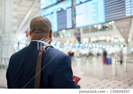Travel, airport or black man walking with passport, suitcase or tickets to customs in New York city. Back view, airplane or African businessman traveling via international flight transportation alone Travel, airport or black man walking with passport, suitcase or tickets to customs in New York city. Back view, airplane or African businessman traveling via international flight transportation alone 130608897