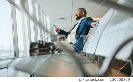 Relax, travel or black man with phone for internet, website search or communication in airport lobby. Smile, happy or girl on tech for communication, networking or social media app in London lounge Relax, travel or black man with phone for internet, website search or communication in airport lobby. Smile, happy or girl on tech for communication, networking or social media app in London lounge 130608899