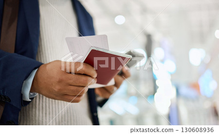 Hands, phone and passport for travel, schedule or ticket checking flight times on mobile app at the airport. Hand of business employee holding smartphone or ID document for traveling, trip or journey Hands, phone and passport for travel, schedule or ticket checking flight times on mobile app at the airport. Hand of business employee holding smartphone or ID document for traveling, trip or journey 130608936
