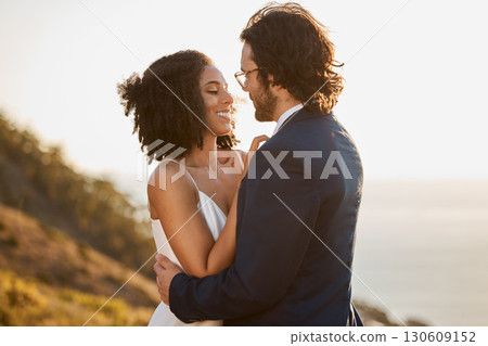 Love, wedding and bride with groom on mountain for marriage ceremony, commitment and celebration. Romance, happiness and interracial couple bonding, hug and smile with ocean, nature and outdoors Love, wedding and bride with groom on mountain for marriage ceremony, commitment and celebration. Romance, happiness and interracial couple bonding, hug and smile with ocean, nature and outdoors 130609152
