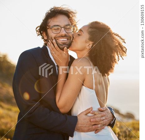Love, kiss and wedding with couple in nature for celebration, happiness and romance. Sunset, hug and affectionate with man and woman in embrace at countryside for happy, marriage and smile together 130609155