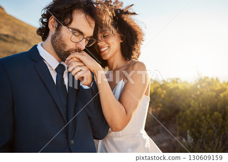 Love, happy and wedding with couple in nature for celebration, happiness and romance. Sunset, hug and affectionate with husband and wife in embrace at countryside for kiss, marriage or smile together 130609159
