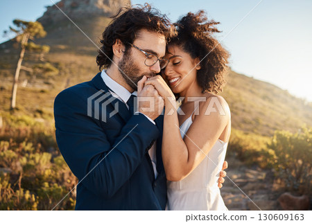 Love, kiss and wedding with couple in nature for celebration, happiness and romance. Sunset, hug and affectionate with bride and groom in embrace at countryside for happy, marriage and smile together 130609163