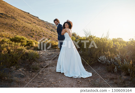 Love, wedding or a couple of friends in countryside after a romantic celebration in an interracial marriage. Life partner, black woman and happy man enjoy a peaceful memory walking as bride and groom Love, wedding or a couple of friends in countryside after a romantic celebration in an interracial marriage. Life partner, black woman and happy man enjoy a peaceful memory walking as bride and groom 130609164