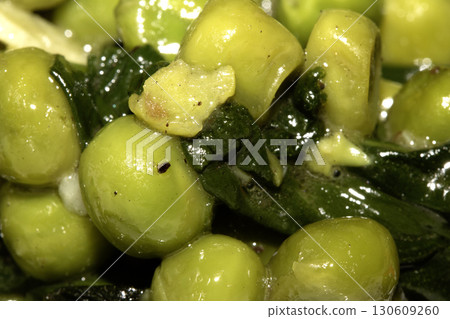 Close up of peas and wilted spinach for roast dinner Close up of peas and wilted spinach for roast dinner 130609260