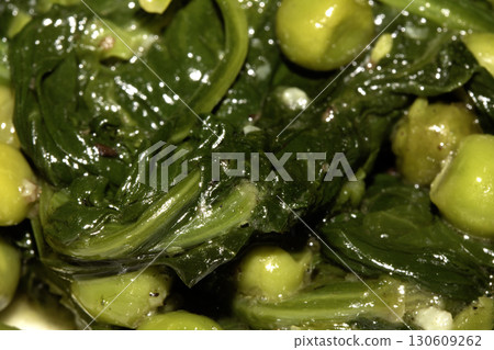 Close up of peas and wilted spinach for roast dinner 130609262