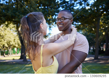 Summer, love and diversity with a couple bonding outdoor together in a park or natural garden. Nature, interracial and romance with a man and woman hugging while on a date outside in the countryside 130609295