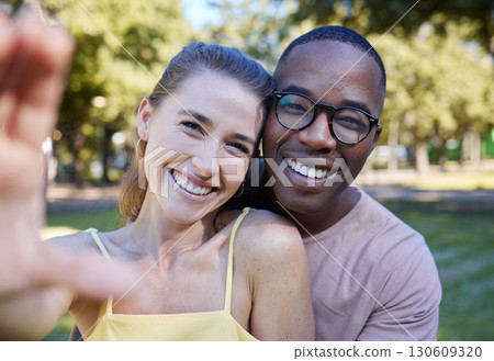 Love, smile and selfie with interracial couple at park for relax, social media and peace on romantic date. Support, happy and quality time with black man and woman for bonding, calm and vacation 130609320