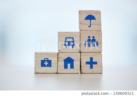 Building blocks of medical, house and life insurance cover on blurred background for family, safety and healthcare icon. Goals, risk management and car, home and umbrella sign on wood for services 130609321