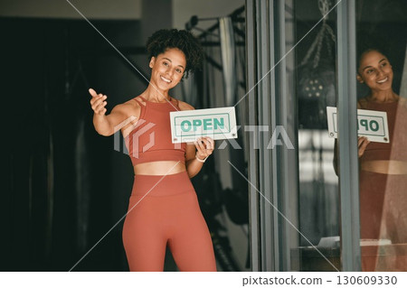 Black woman, welcome and gym owner with open sign for fitness or coaching exercise. Portrait of African American female, sports entrepreneur and training manager or personal trainer at entrance 130609330
