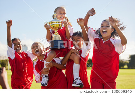 Football, team and trophy with children in celebration together as a girl winner group for a sports competition. Soccer, teamwork and award with sport player kids celebrating success outdoor 130609340