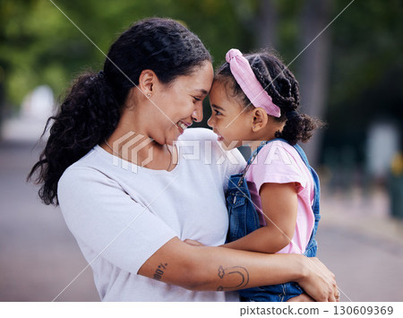 Love, family and mother carrying girl outdoors, bonding and hugging. Motherhood support, care and woman embrace, hug or cuddle with daughter, child or kid and enjoying quality time together at park. 130609369