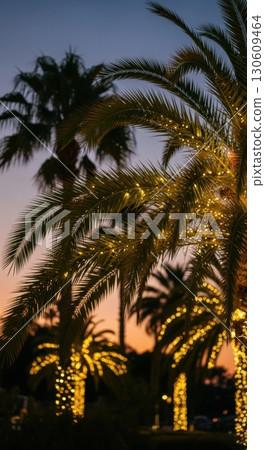 Tropical evening serenity with lit palm trees at sunset 130609464