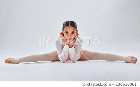 Ballet, dancer and young girl doing the split, smile in portrait with fitness, dancing and sport isolated on white studio background. Ballerina, training and dance in studio, athlete and stretching 130610061