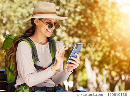 Happy woman, backpack and phone in travel, sightseeing or adventure in nature park, trees forest or Canada woods. Smile, tourist and mobile technology for gps map, 5g location or hiking path research Happy woman, backpack and phone in travel, sightseeing or adventure in nature park, trees forest or Canada woods. Smile, tourist and mobile technology for gps map, 5g location or hiking path research 130610186