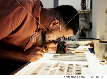 Man, photographer and magnifying glass for film negatives, zoom and analysis for photo journalist job. Photography expert, analyse picture and focus in studio for choice, art decision and creativity 130610190