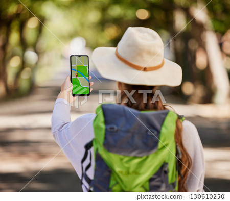 Navigation, phone and woman hiking in a forest for exercise, adventure or wellness in nature. GPS app, direction and female hiker trekking on an outdoor trail in the woods alone with a mobile map. Navigation, phone and woman hiking in a forest for exercise, adventure or wellness in nature. GPS app, direction and female hiker trekking on an outdoor trail in the woods alone with a mobile map. 130610250