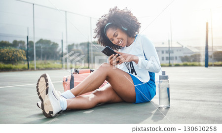 Netball sports, phone music and athlete listening to mp3 radio, audio podcast or song after training workout. Laughing on court, online digital headphones and black woman streaming funny meme video 130610258