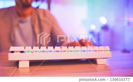 Keyboard, pc gamer and man hands in gaming neon room, futuristic workspace or fast coding software developer. Typing, cyberpunk and online streamer on esports video game for information technology Keyboard, pc gamer and man hands in gaming neon room, futuristic workspace or fast coding software developer. Typing, cyberpunk and online streamer on esports video game for information technology 130610377