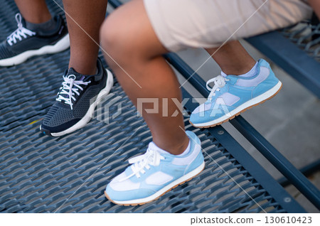 Close up picture of two two people feet in sneakers Close up picture of two two people feet in sneakers 130610423