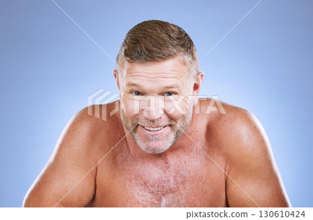 Portrait, skincare and hygiene with a mature man in studio on a blue background for cleaning or beauty. Face, wellness and health with a handsome older male posing to promote natural skin treatment Portrait, skincare and hygiene with a mature man in studio on a blue background for cleaning or beauty. Face, wellness and health with a handsome older male posing to promote natural skin treatment 130610424