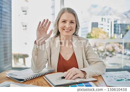 Video call, senior and business woman wave in office, conference or meeting. Greeting, hello and portrait of elderly female worker from Canada waving in webinar, workshop or online chat in workplace. 130610438