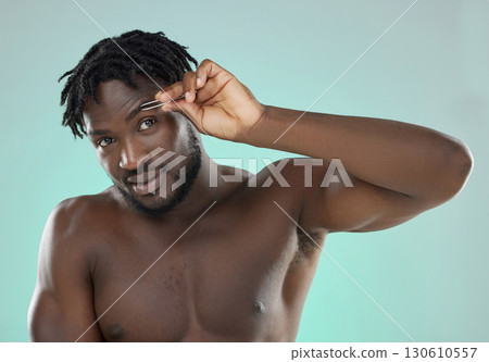 Black man, eyebrow and tweezer in studio for portrait, beauty grooming or cosmetics by blue background. Model, cosmetic and facial hair removal with metal tools for aesthetic, skincare or self care 130610557