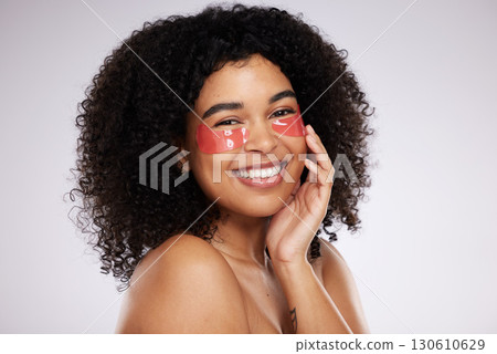 Eye mask, beauty and portrait with a model black woman in studio on a gray background for skincare or cosmetics. Spa, relax and facial with an attractive young female posing to promote wellness 130610629