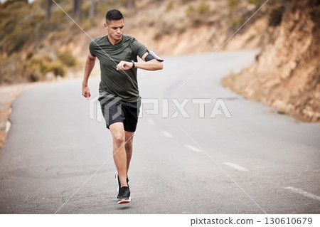 Smart watch, man and running in road for exercise, cardio workout and marathon training in nature. Stopwatch, sports runner and athlete check time, heart rate or monitor body progress of health goals 130610679