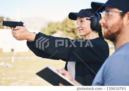 Gun range, target practice and woman holding a rifle for safety, security and police training. Field, exercise, and learning to fire at a outdoor academy with mentor and shooting gear for challenge Gun range, target practice and woman holding a rifle for safety, security and police training. Field, exercise, and learning to fire at a outdoor academy with mentor and shooting gear for challenge 130610763